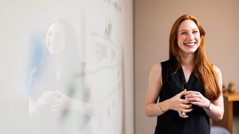 Stock photo - person next to a whiteboard smiling banner