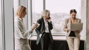 Stock photo - 3 people in suits at office smiling banner