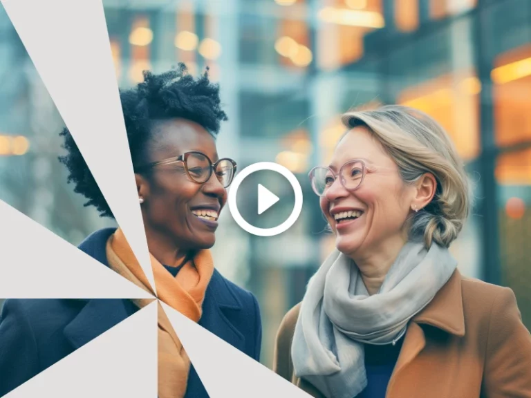 Two women in business attire talking and smiling - Valona AI photo